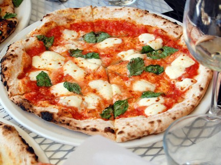 Tomato based pizza with mozzeralla and basil